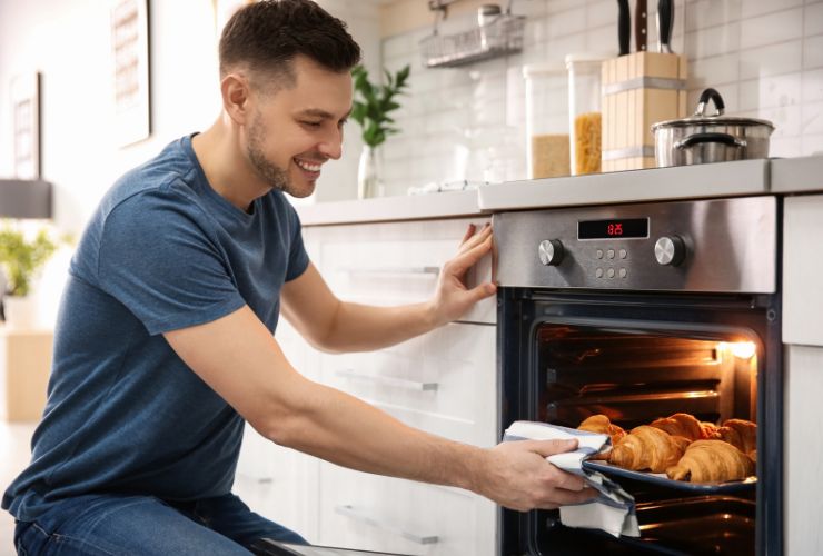 man using oven