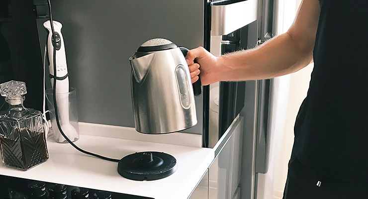 man using electric kettle