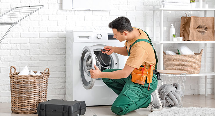electrician working on washing machine an essential appliance