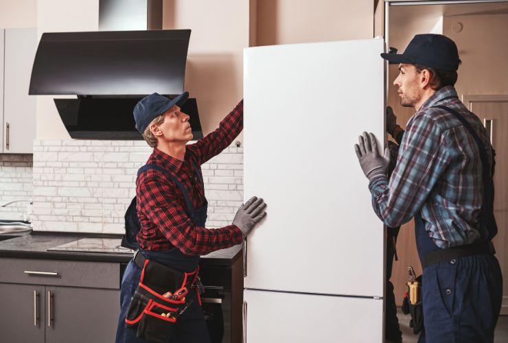electricians carrying a refrigerator