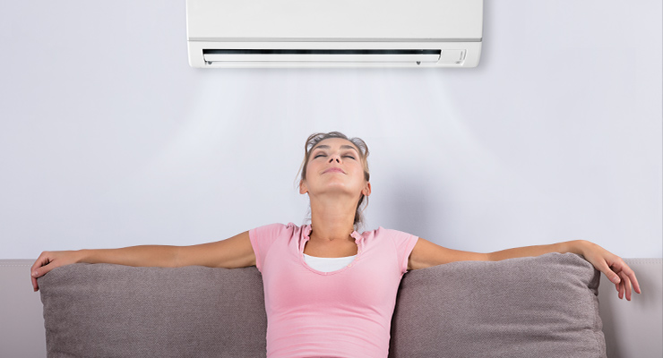 Girl sitting in front air conditioner