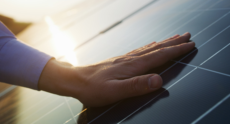 hand leaning on solar panel