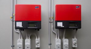 two red inverters installed on wall