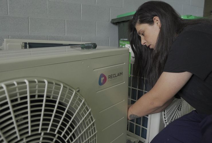 woman installing heat pump