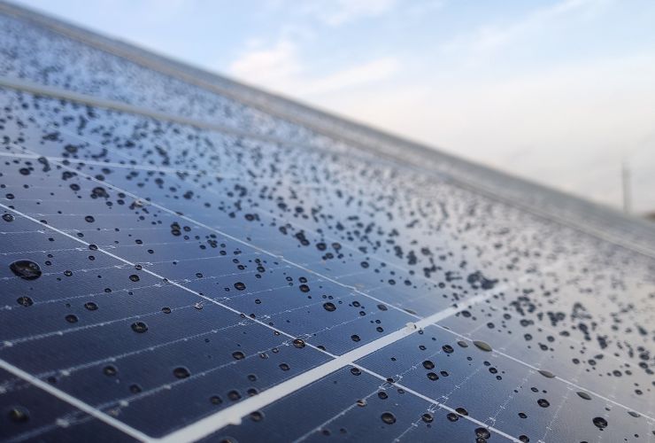 Solar panel affected on a sunny day with rain droplets