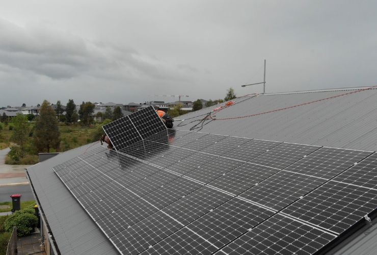 installers on roof with solar panels