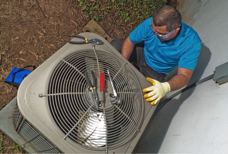 installer working on outdoor air conditioning unit