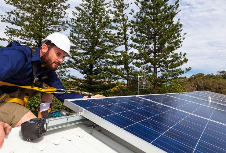 installer measuring solar panel