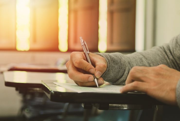 person writing on piece of paper