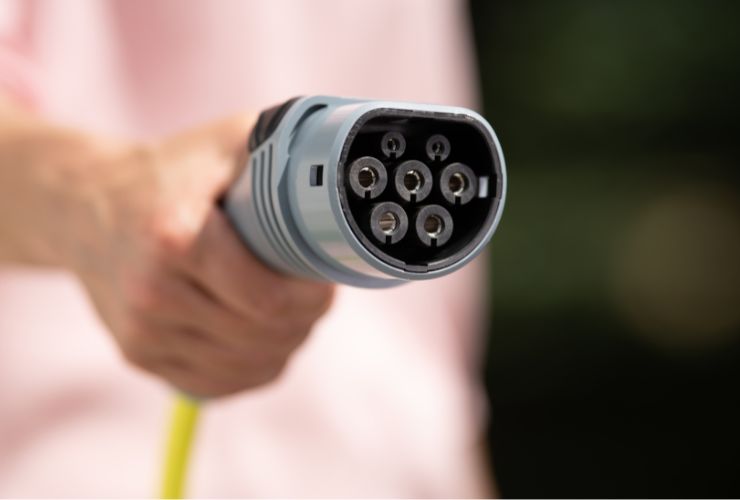 electric car charger being held