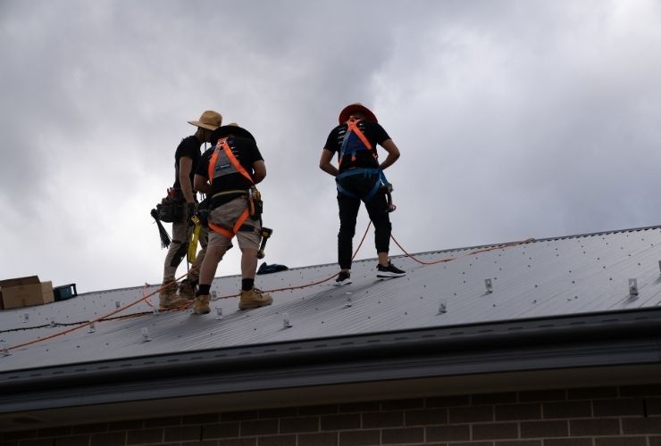 solar installers walking on roof