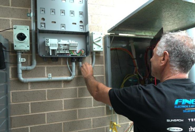 installer inspecting electric meter