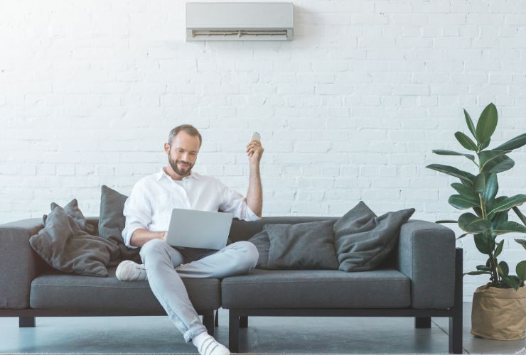 Relaxed guy turning on air con