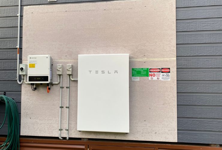 Tesla Powerwall on the side of a house