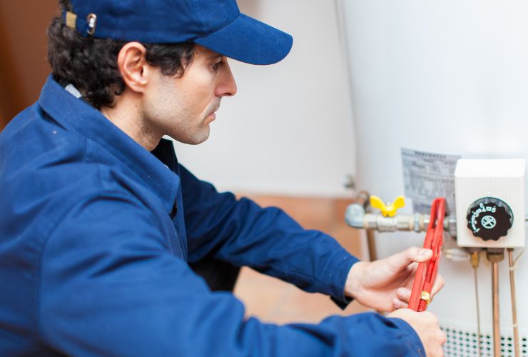 installer working on hot water tank