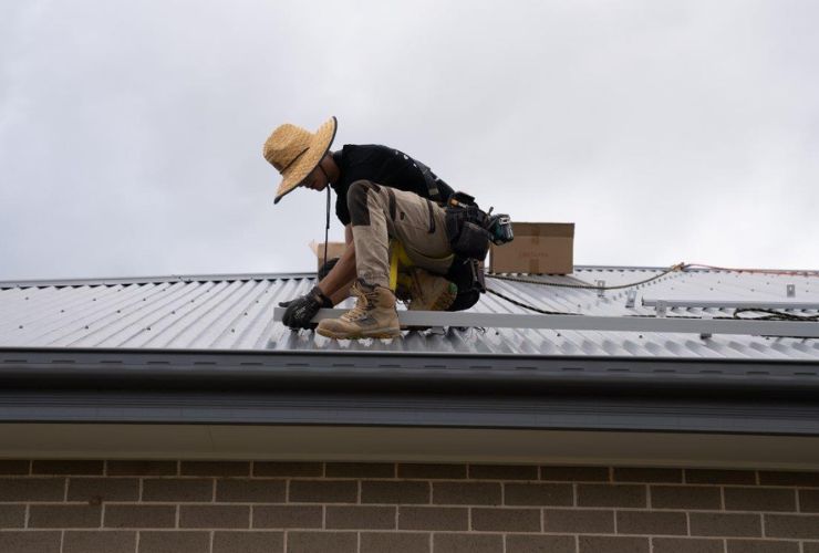 installer on roof installing solar