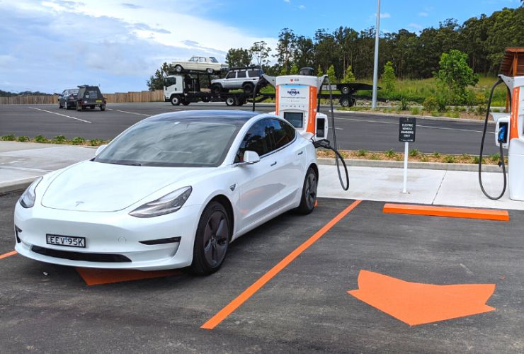 tesla charging at a public charging station