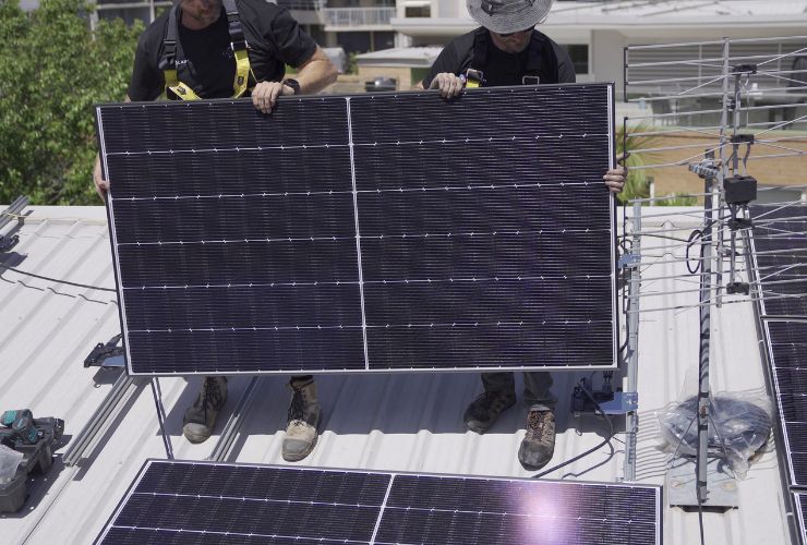 installers adding solar panels to solar system