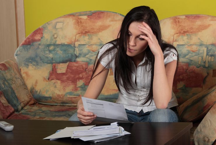 woman looking at bill upset because solar system is not working properly