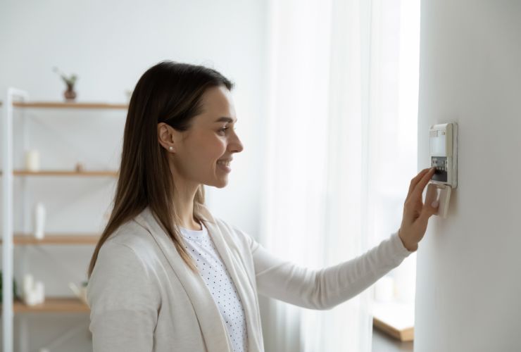 woman using air con panel