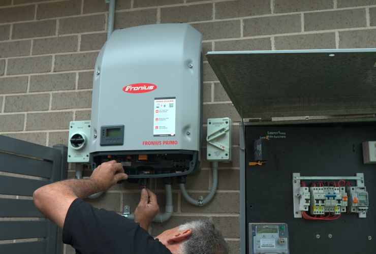 installer inspecting inverter