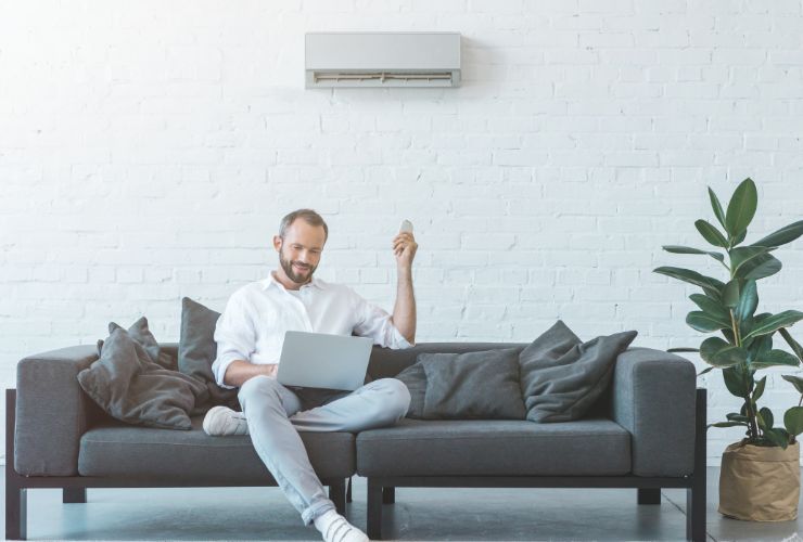 man using air conditioner in home