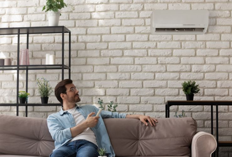 man using air conditioner heater