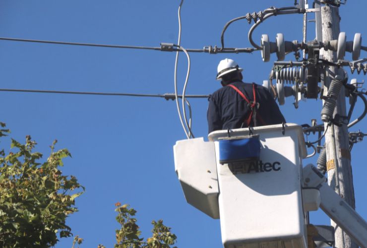 man working on electricity cables for a home after power outage