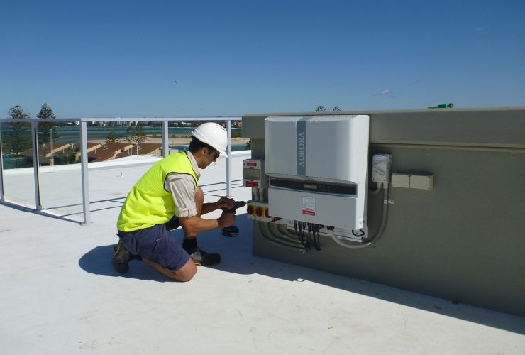 Man Installing commercial solar inverter