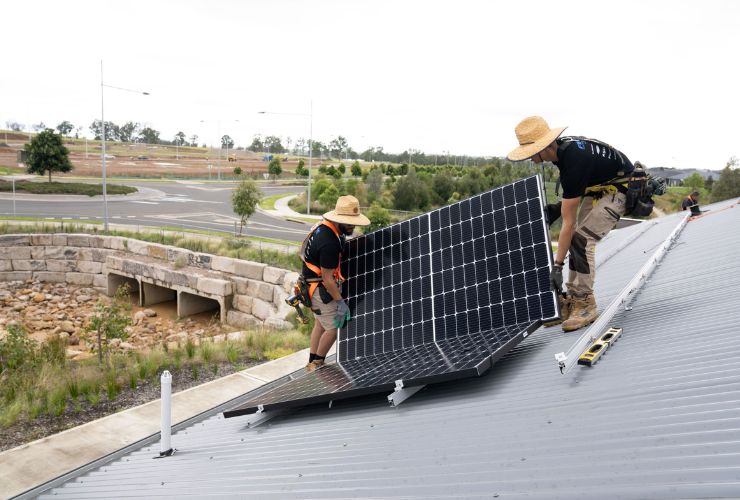 two men installing half-cut solar cell panel 