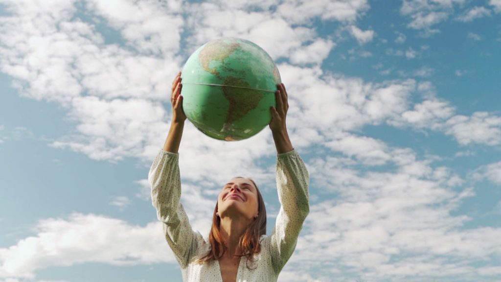 Young person holding a world ball