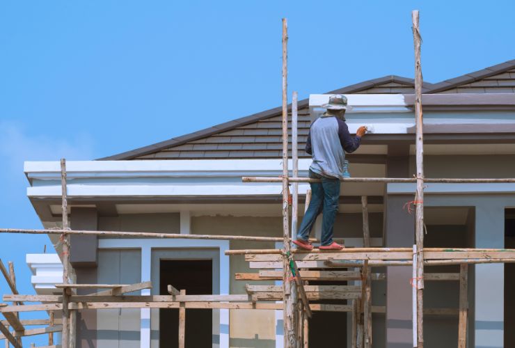 builder painting the roof