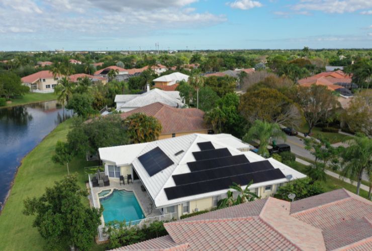 home with black solar panels producing energy