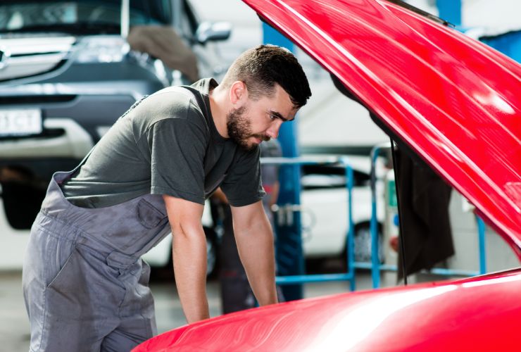 mechanic looking at engine