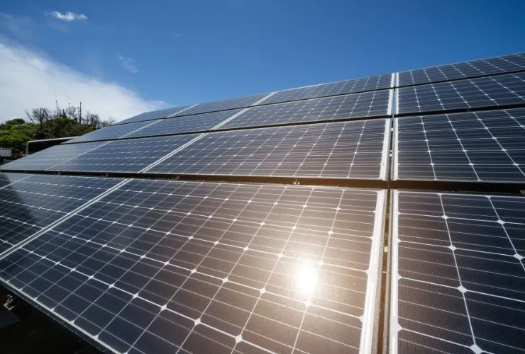 sun shining on solar panel