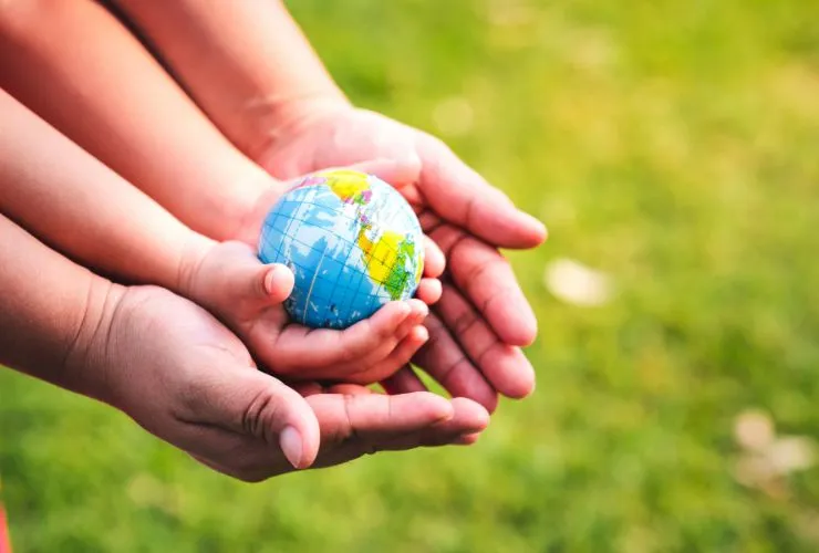 hands holding toy globe