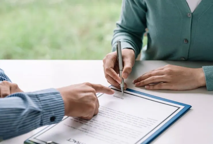 man signing piece of paper for solar quote