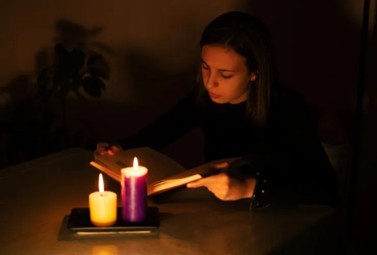 women using candle during blackout