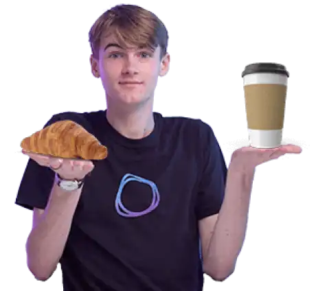 Jono holding a cup of coffee and a croissant