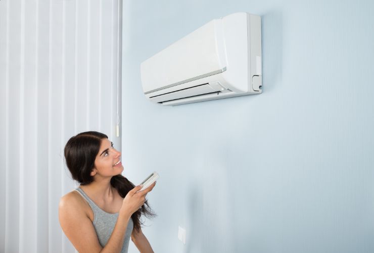 resident enjoying air conditioner unit