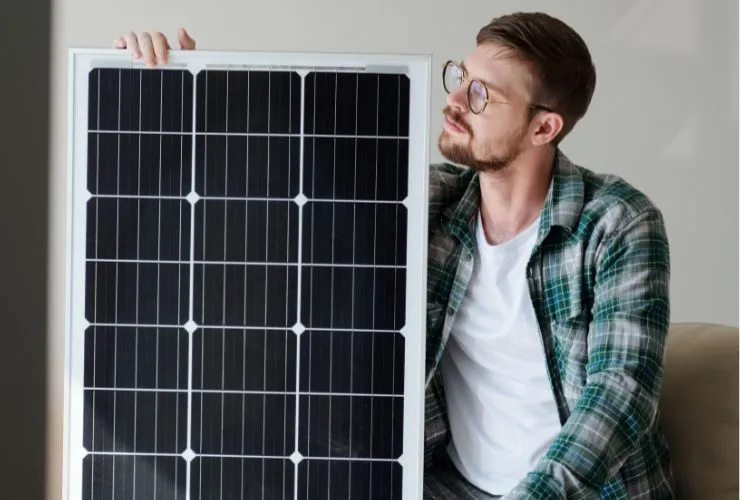 man looking at solar panel