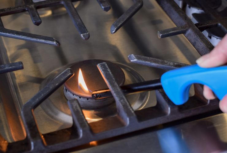 gas stove top being lit with lighter
