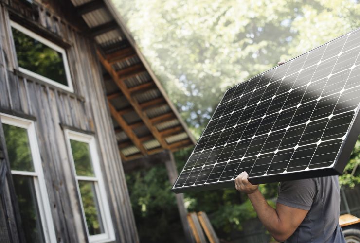 installer carrying solar panel