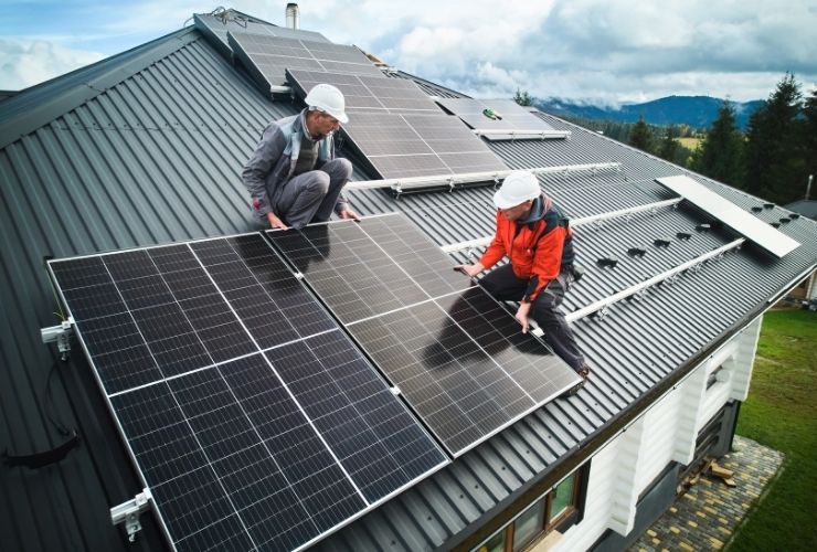 installers working on roof installing solar panels