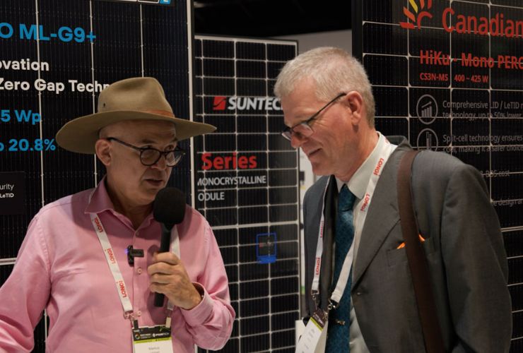 markus interviewing Jeff in front of solar panels